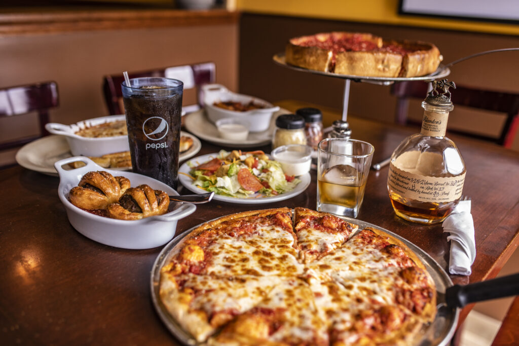 traditional cheese pizza, appetizer, salad, drink, and chicago style deep dish