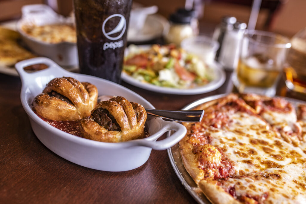 assortment of dining options, salad, app, and pizza.