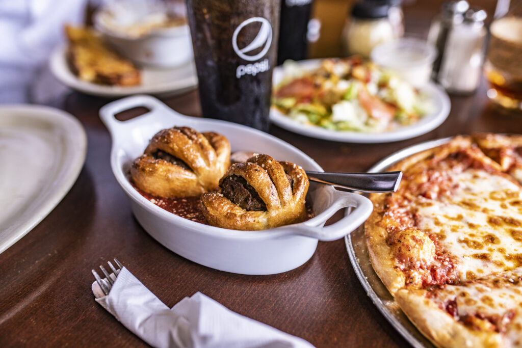 assortment of dining options, salad, app, and pizza.